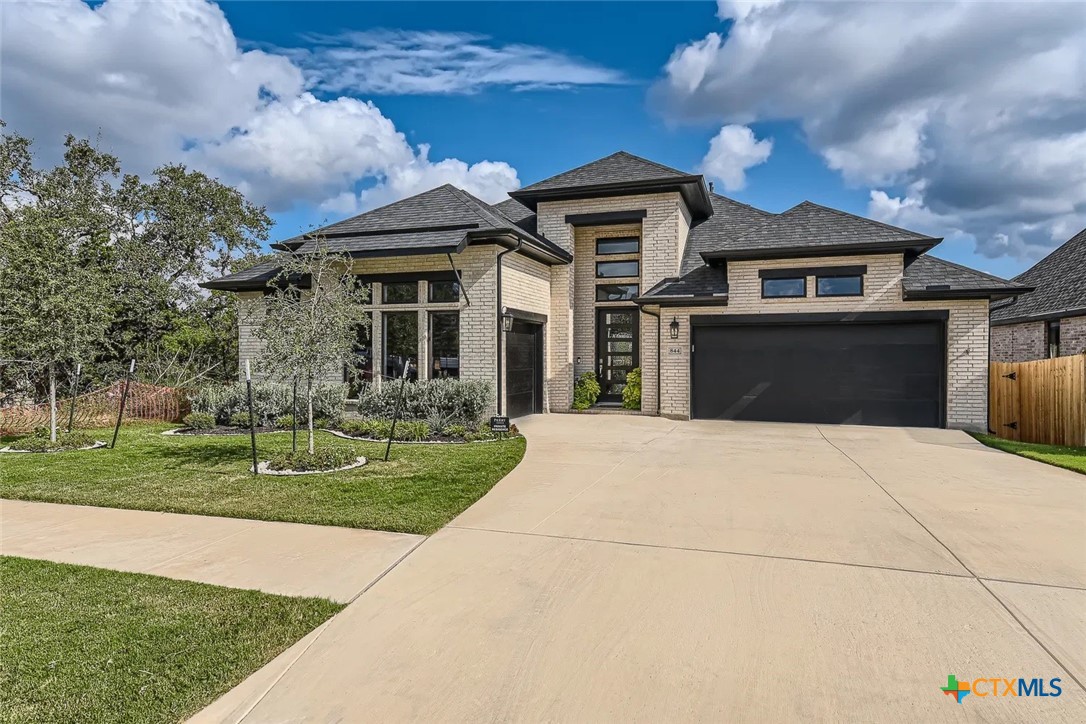 a front view of a house with a yard