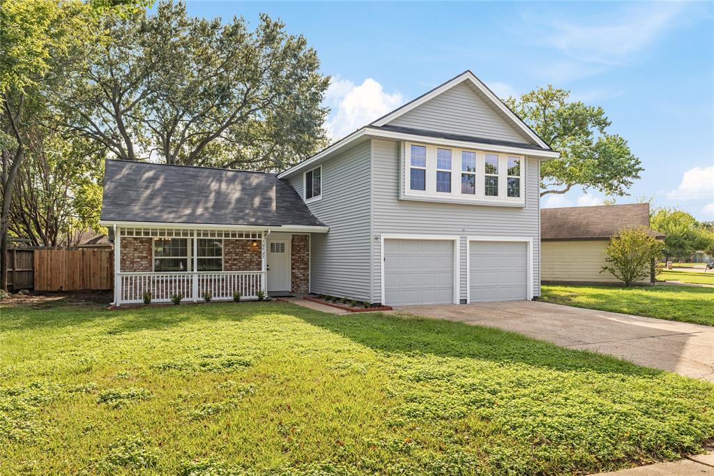 a view of a house with a yard and garage