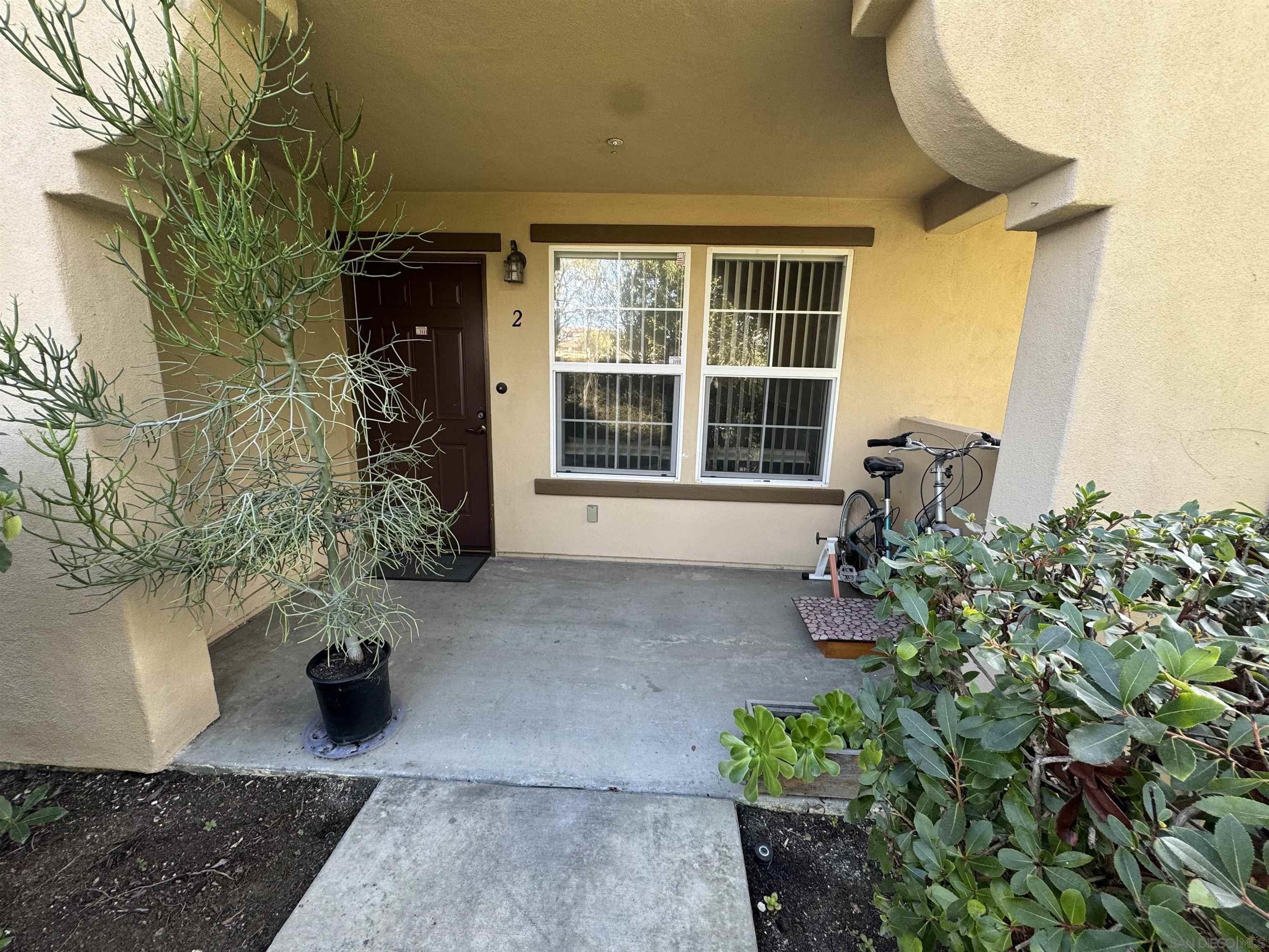 a view of a house with potted plants