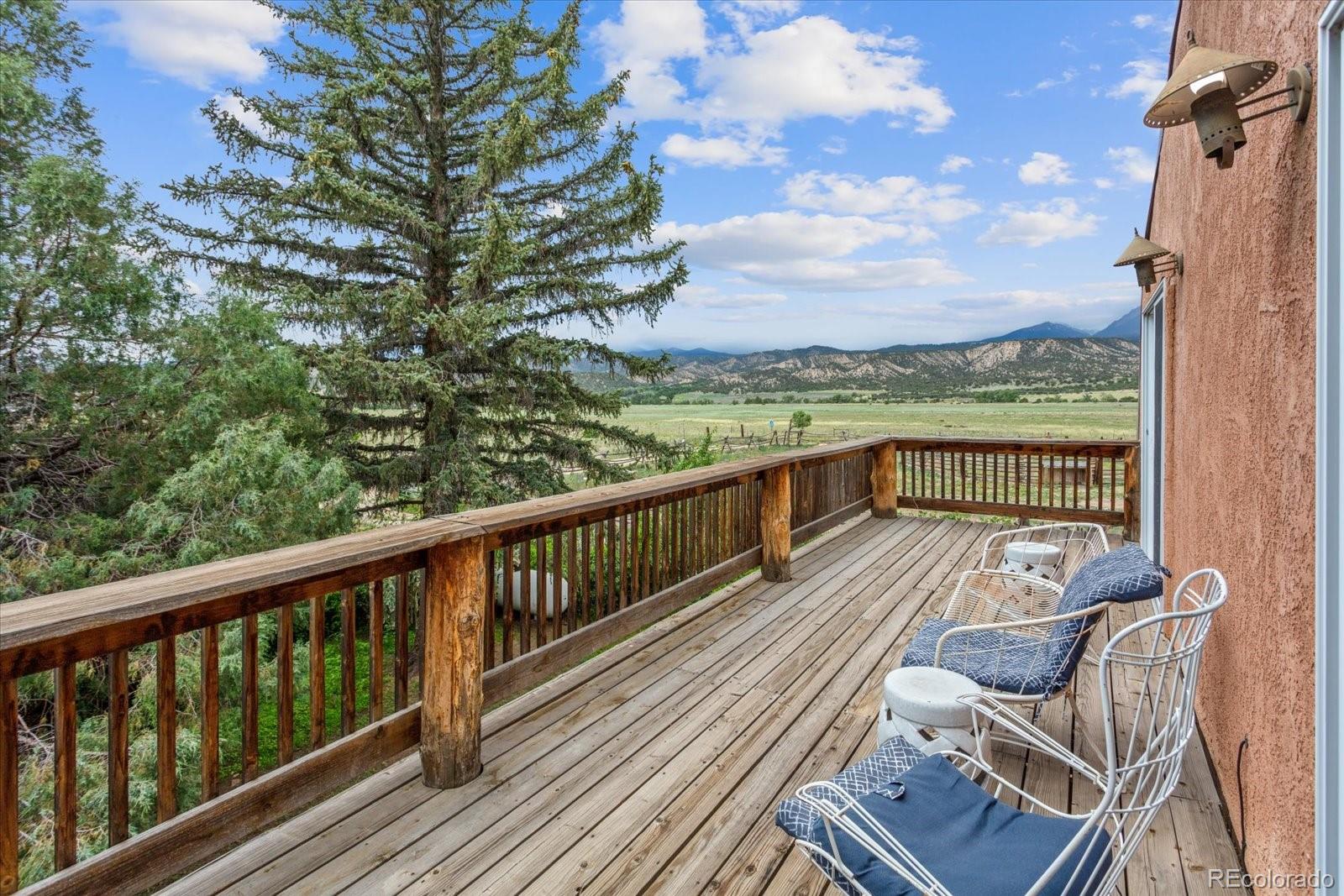 a view of balcony with wooden floor and outdoor seating