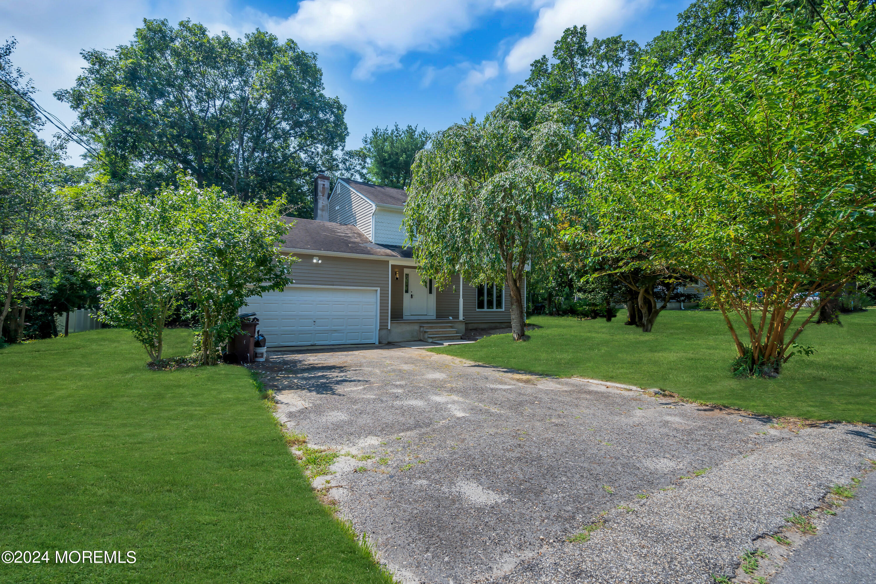 a front view of a house with a yard and a garage