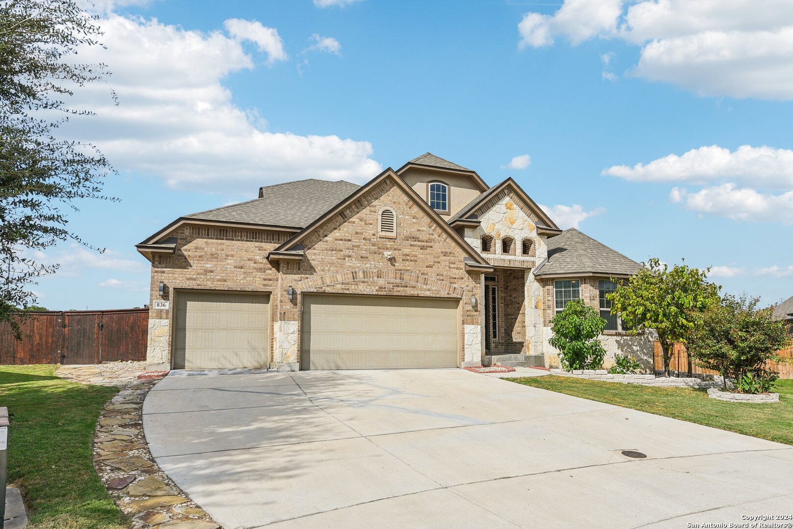 a front view of a house with garden