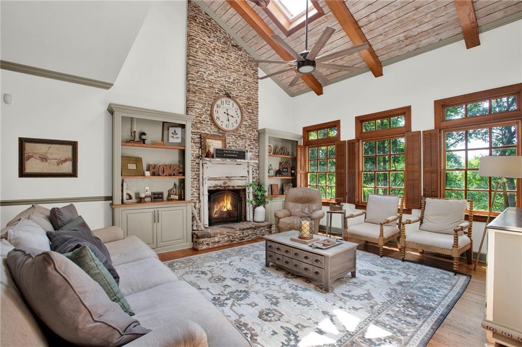 a living room with furniture large window and a fireplace