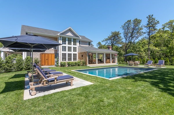 a view of a house with a yard and sitting area