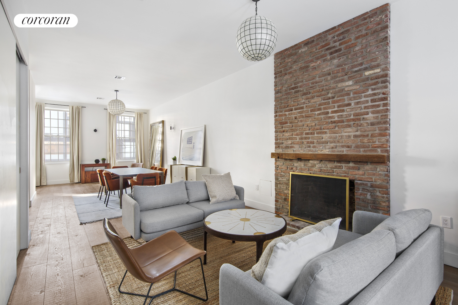 a living room with furniture a fireplace and a chandelier