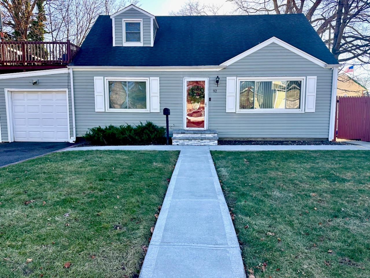 View of front of home featuring a garage and a front lawn