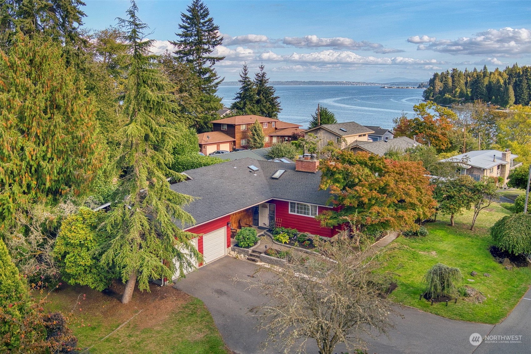 an aerial view of residential houses with outdoor space and trees