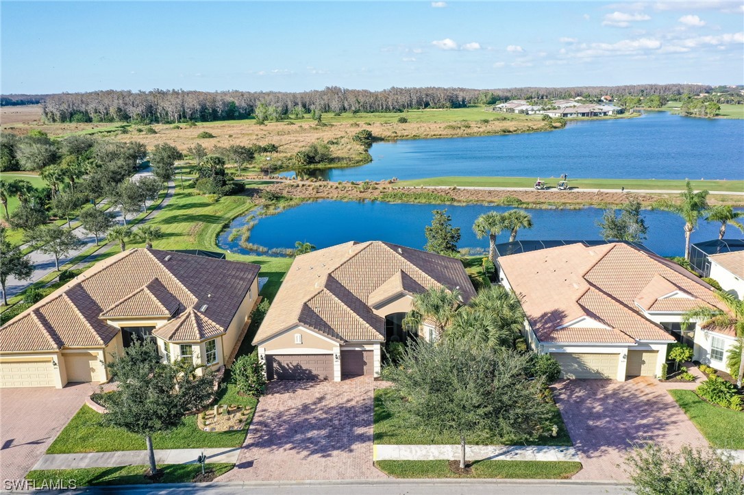 an aerial view of a house with a garden and lake view