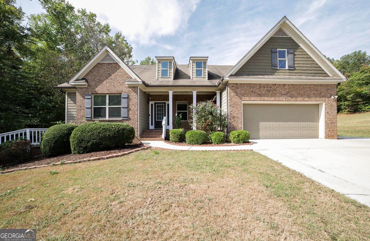 a front view of a house with a yard and garage