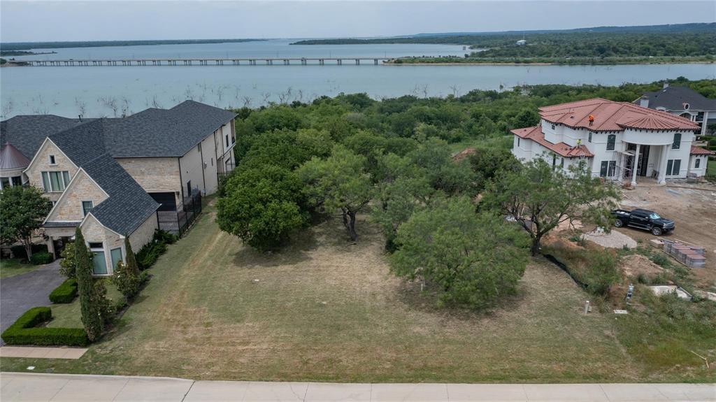 an aerial view of a house with garden space and lake view