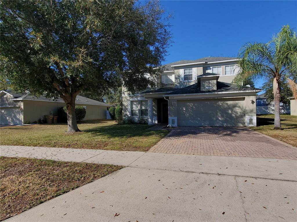 a front view of a house with a yard and a garage