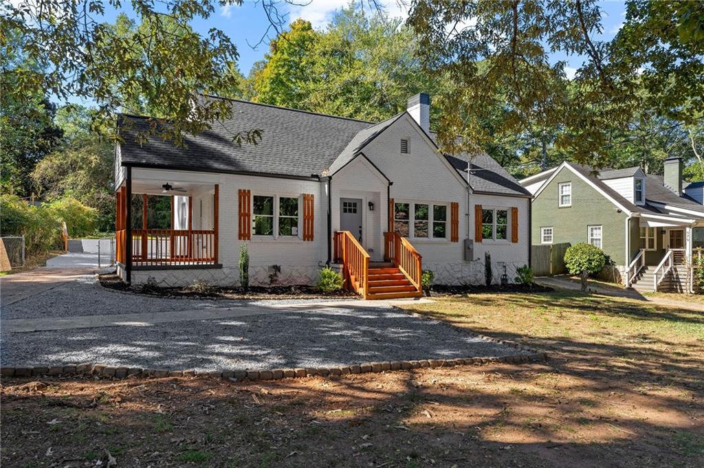 a view of a house with backyard and sitting area