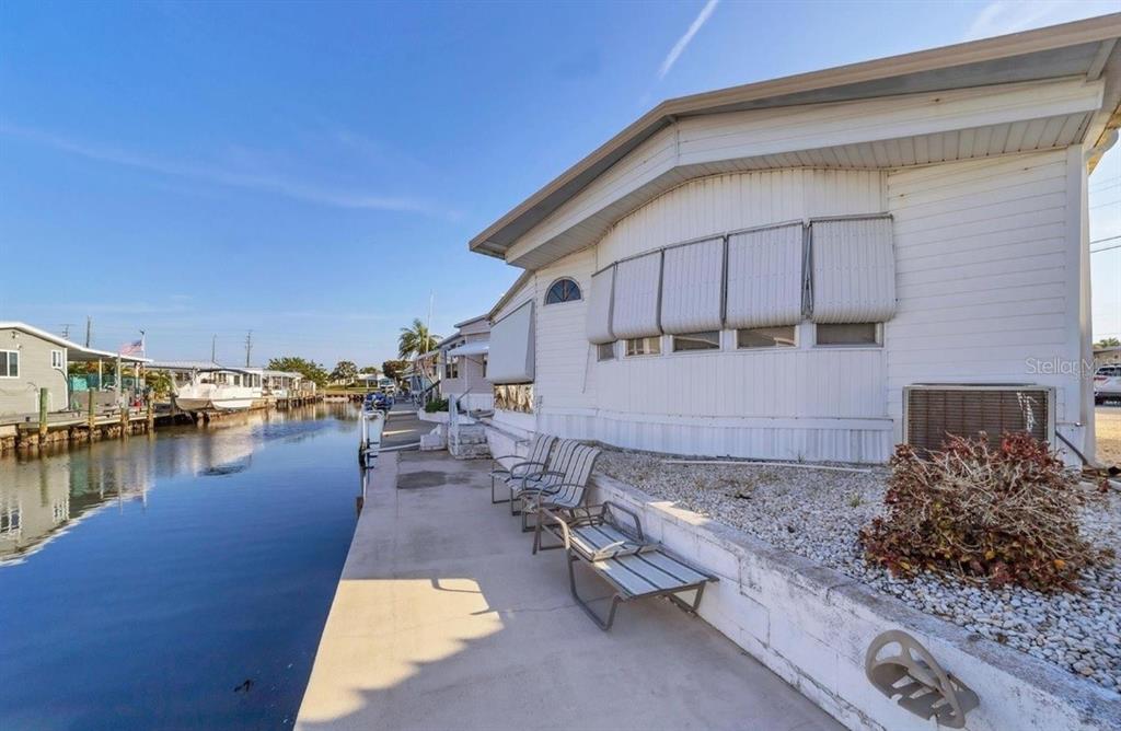 a view of a house with yard and lake view