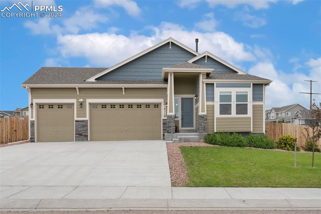 a front view of a house with a yard and garage