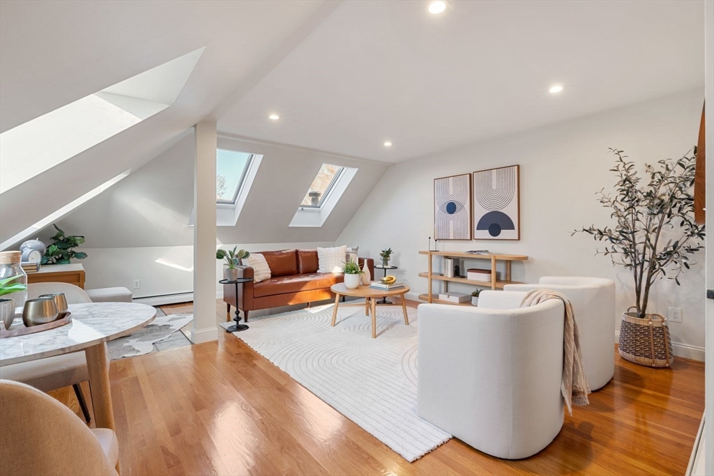 a living room with furniture and a potted plant