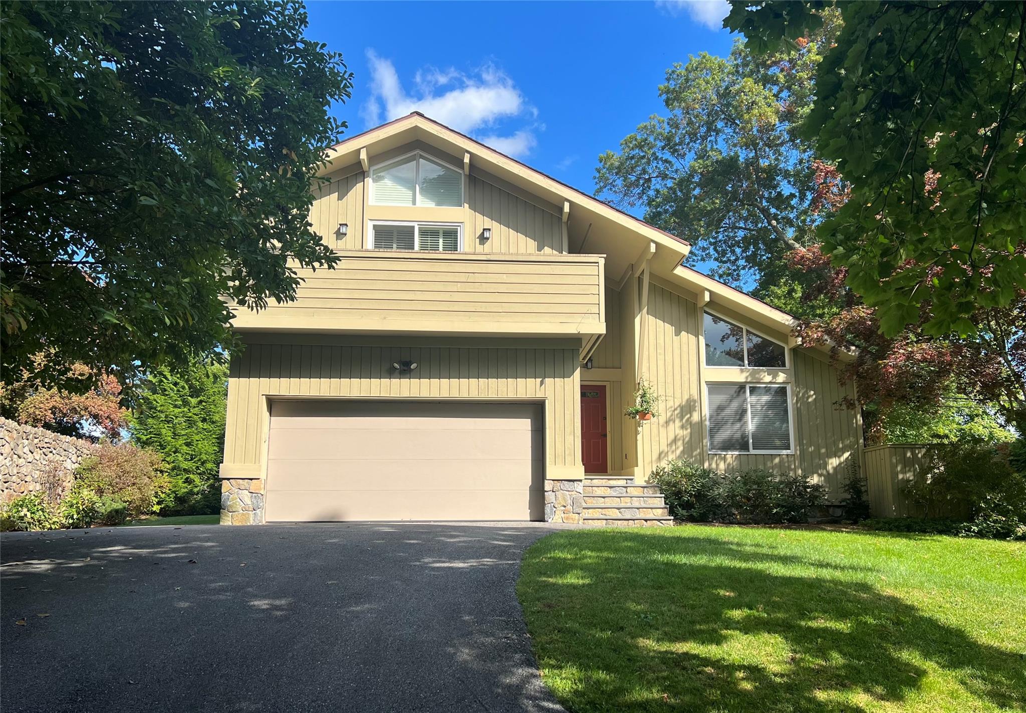 View of front of house with a garage and a front lawn