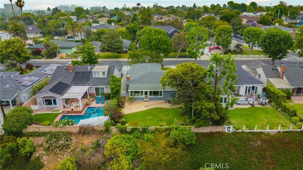 an aerial view of multiple houses with yard