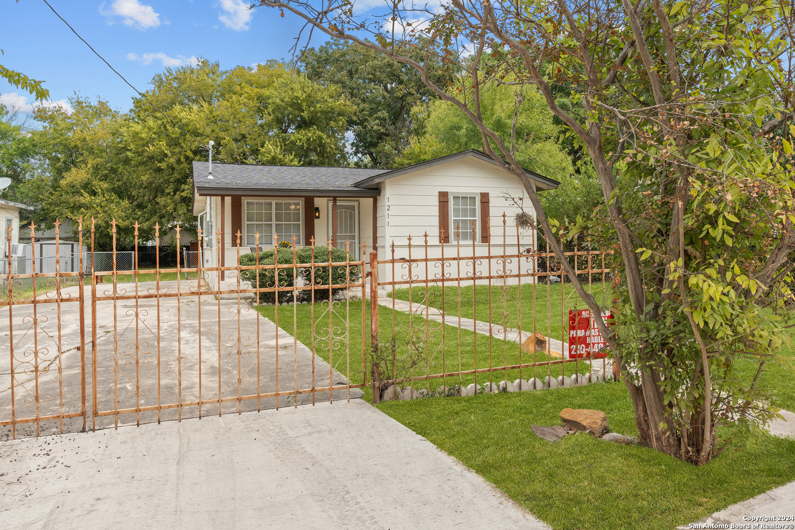 a view of a house with a backyard