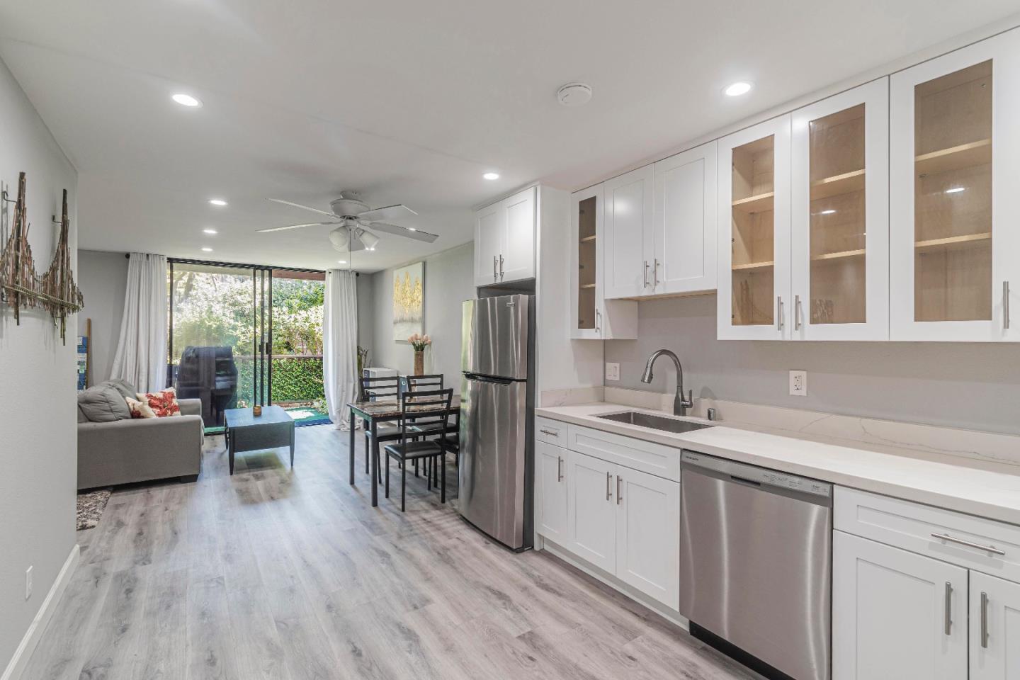 a kitchen with a sink a counter top space and stainless steel appliances