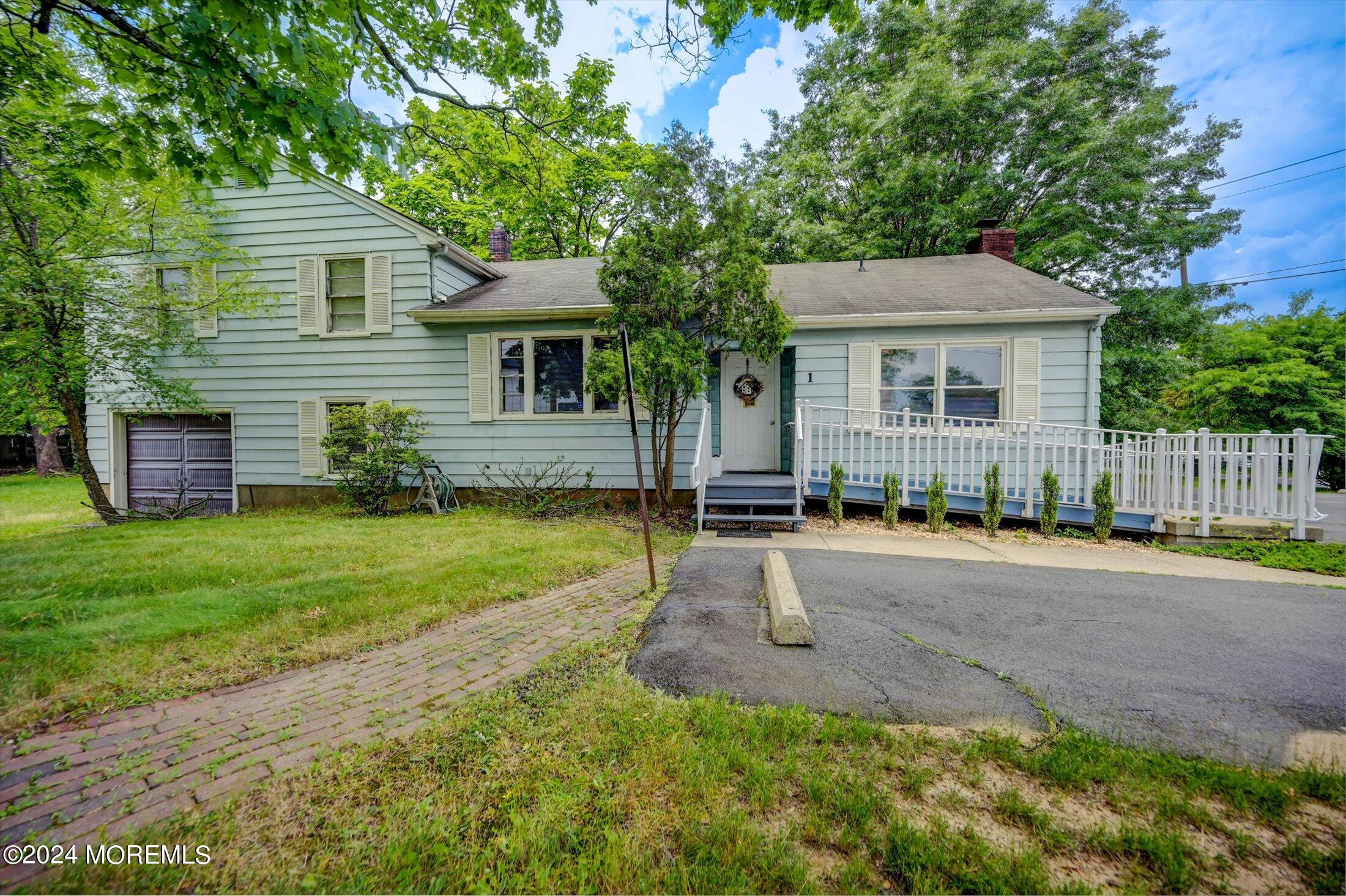 a front view of house with yard and trees