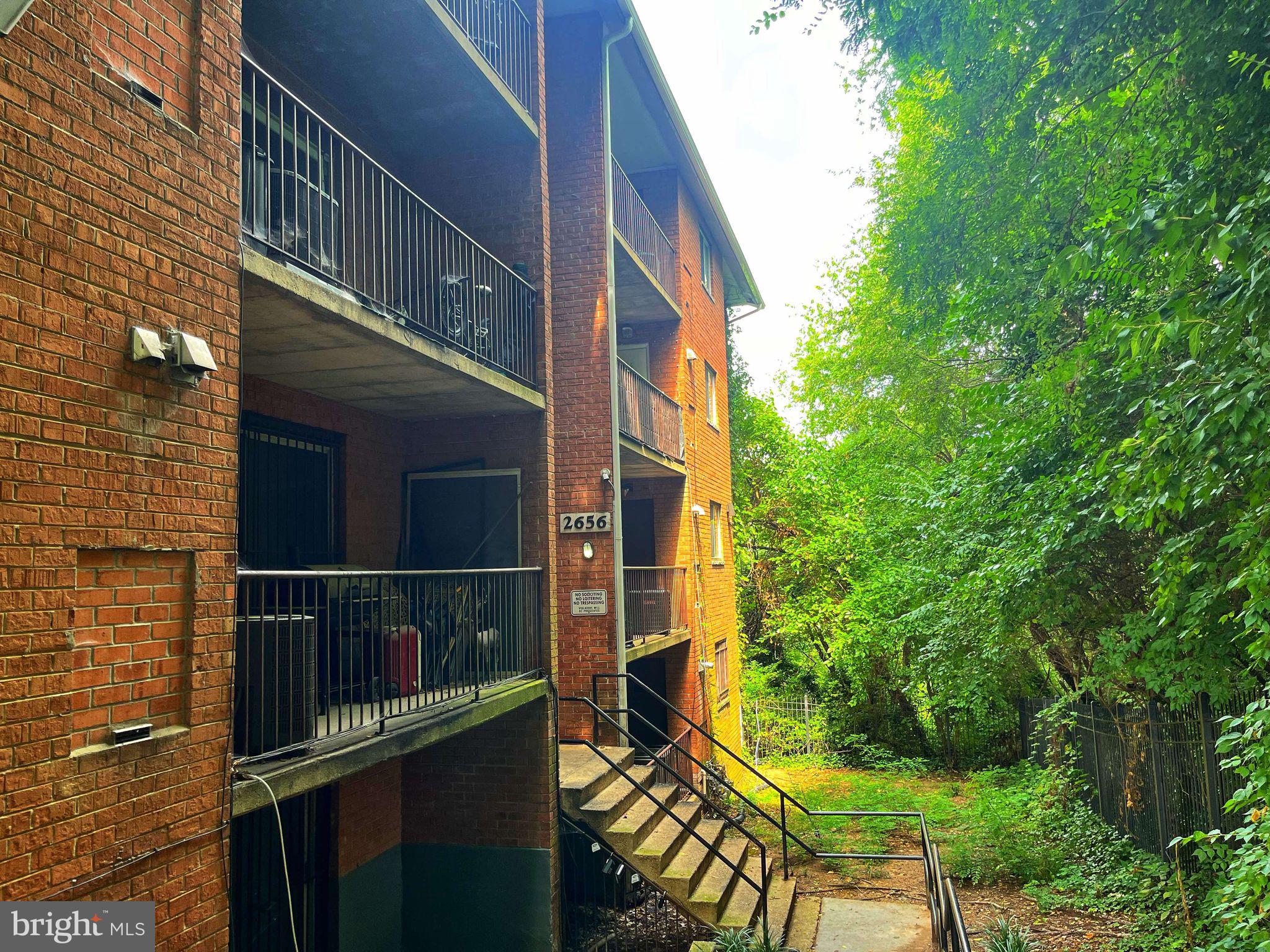 a balcony view with a backyard space