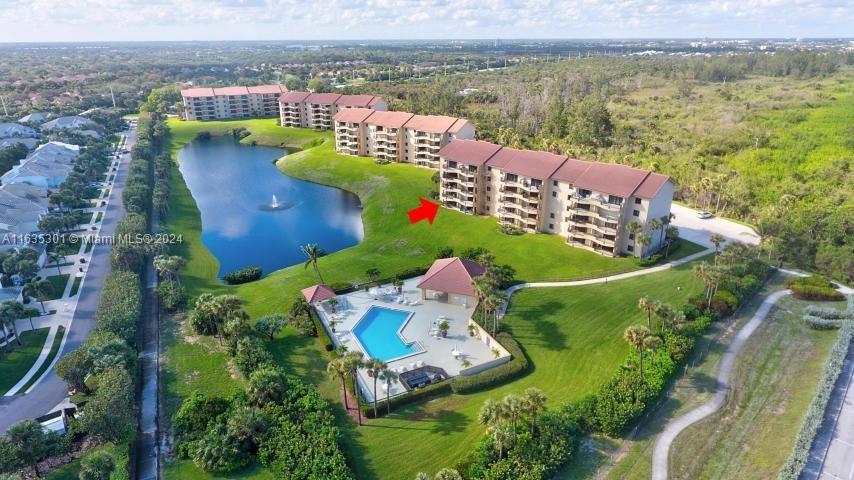 an aerial view of a house with a garden and lake view