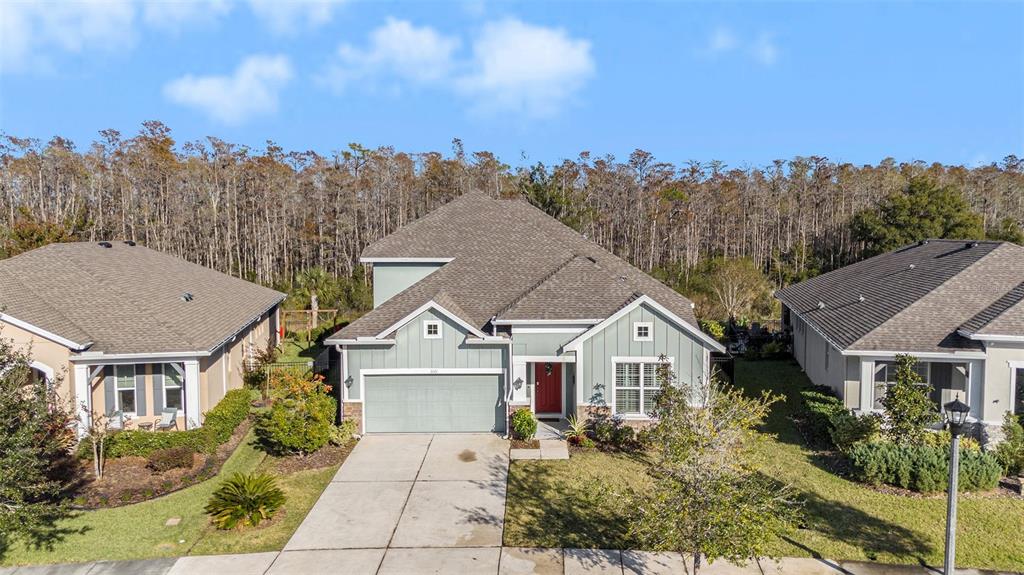 a aerial view of a house next to a yard