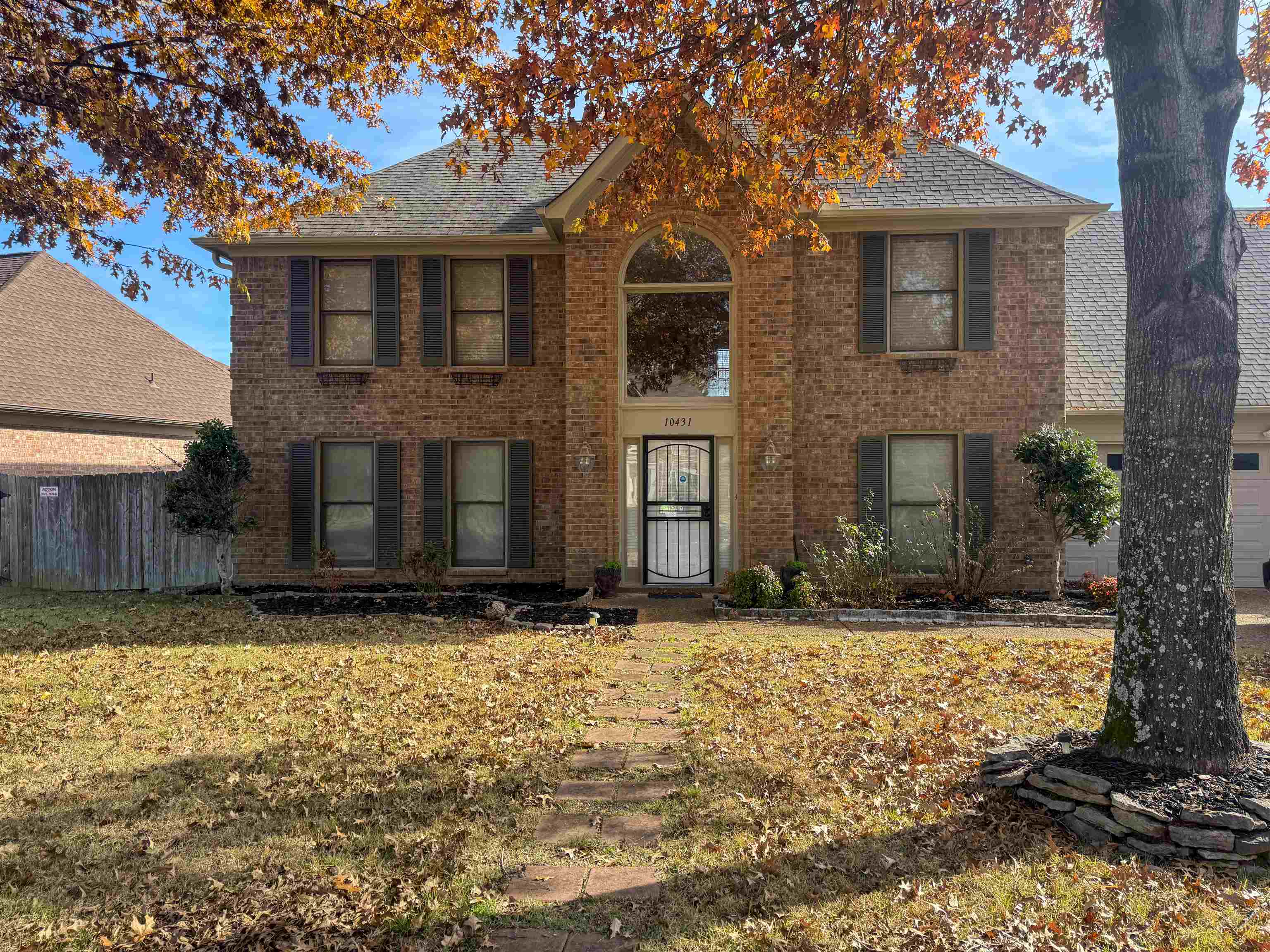 a view of a brick house with a yard