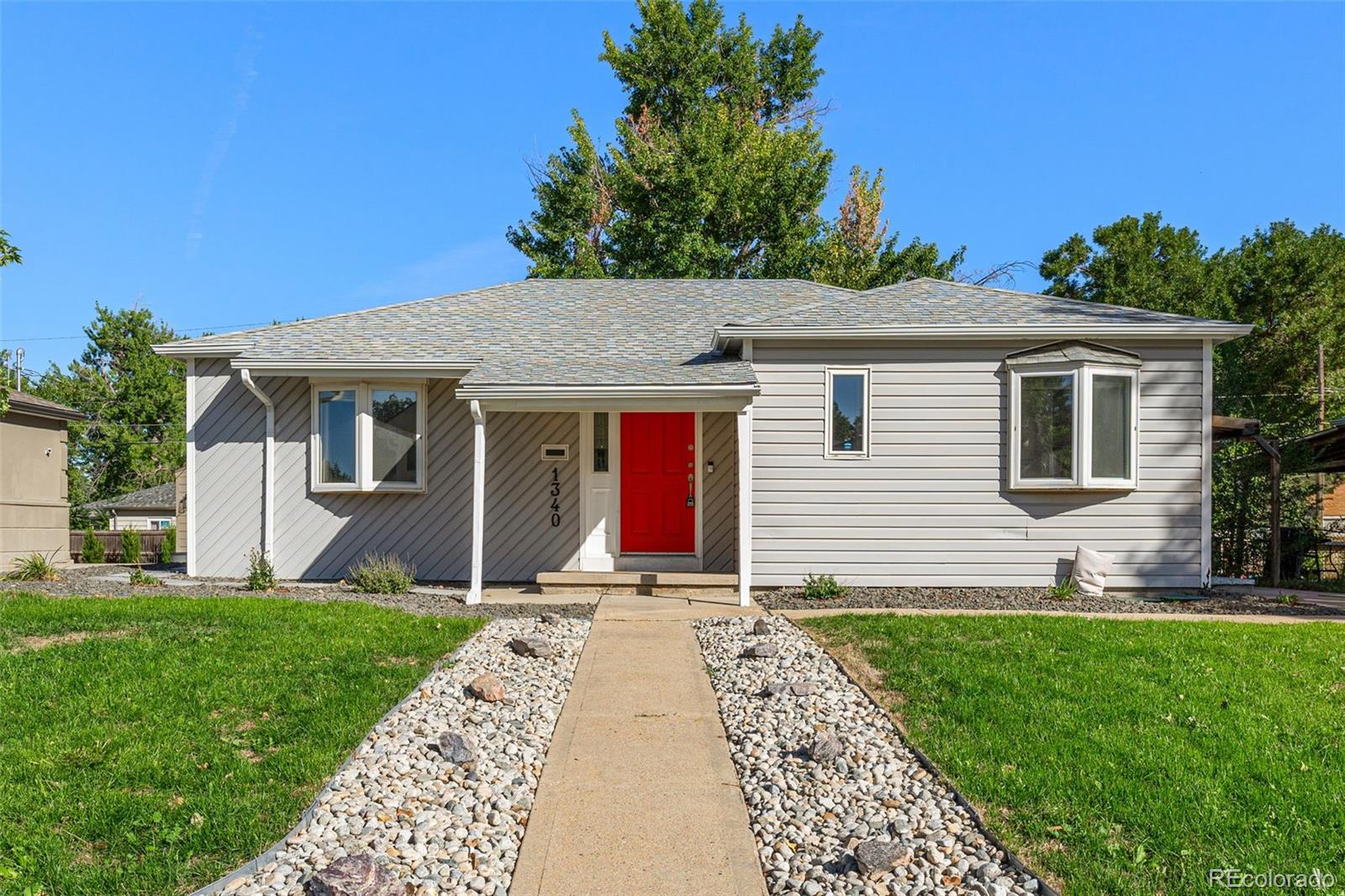 a front view of house with yard and green space