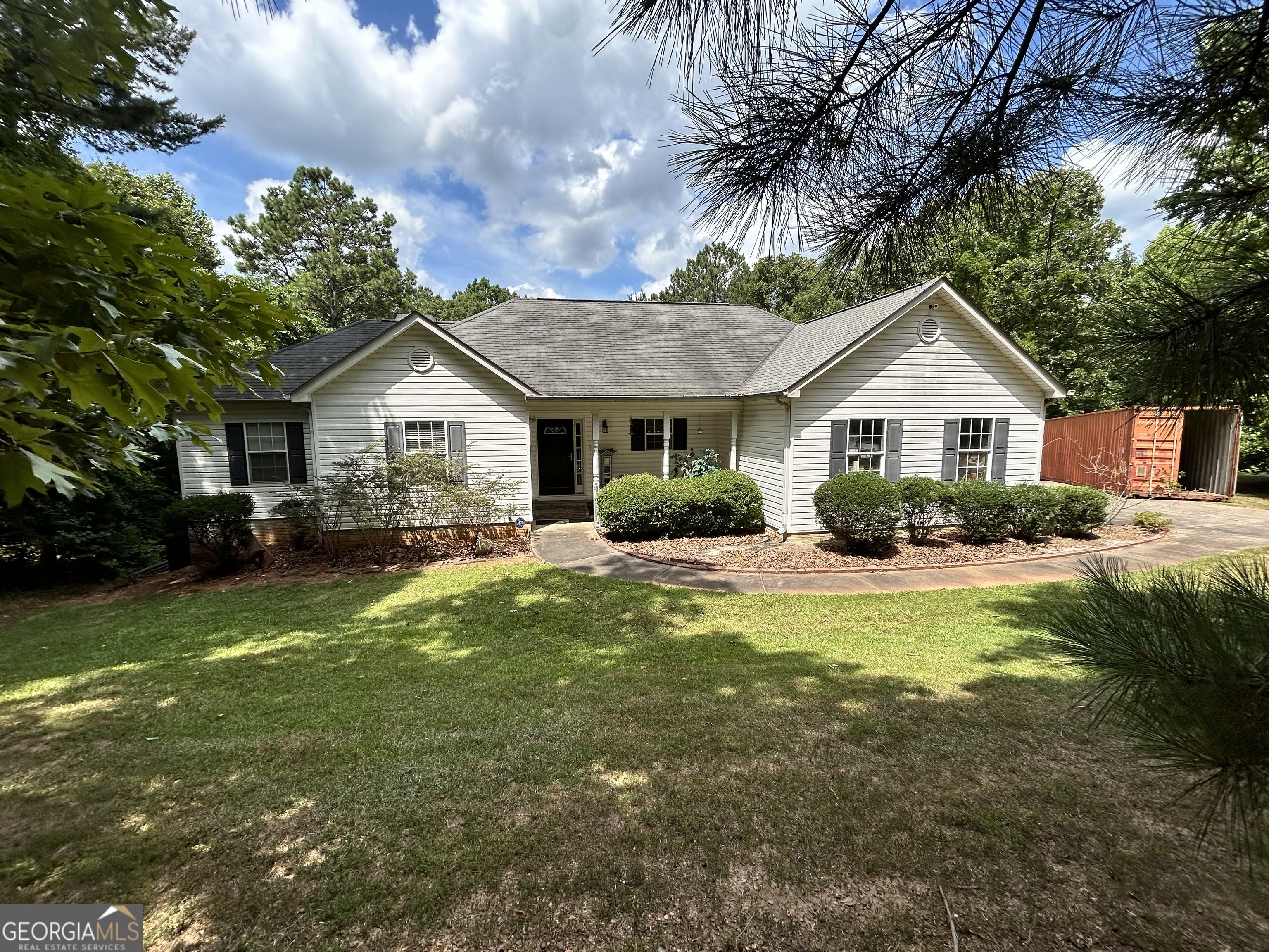 a front view of a house with swimming pool having outdoor seating