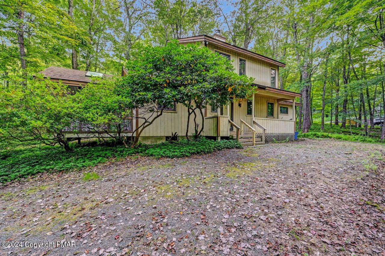 a view of a house with a tree