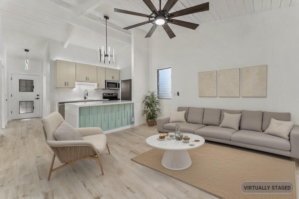 a living room with furniture and a kitchen view