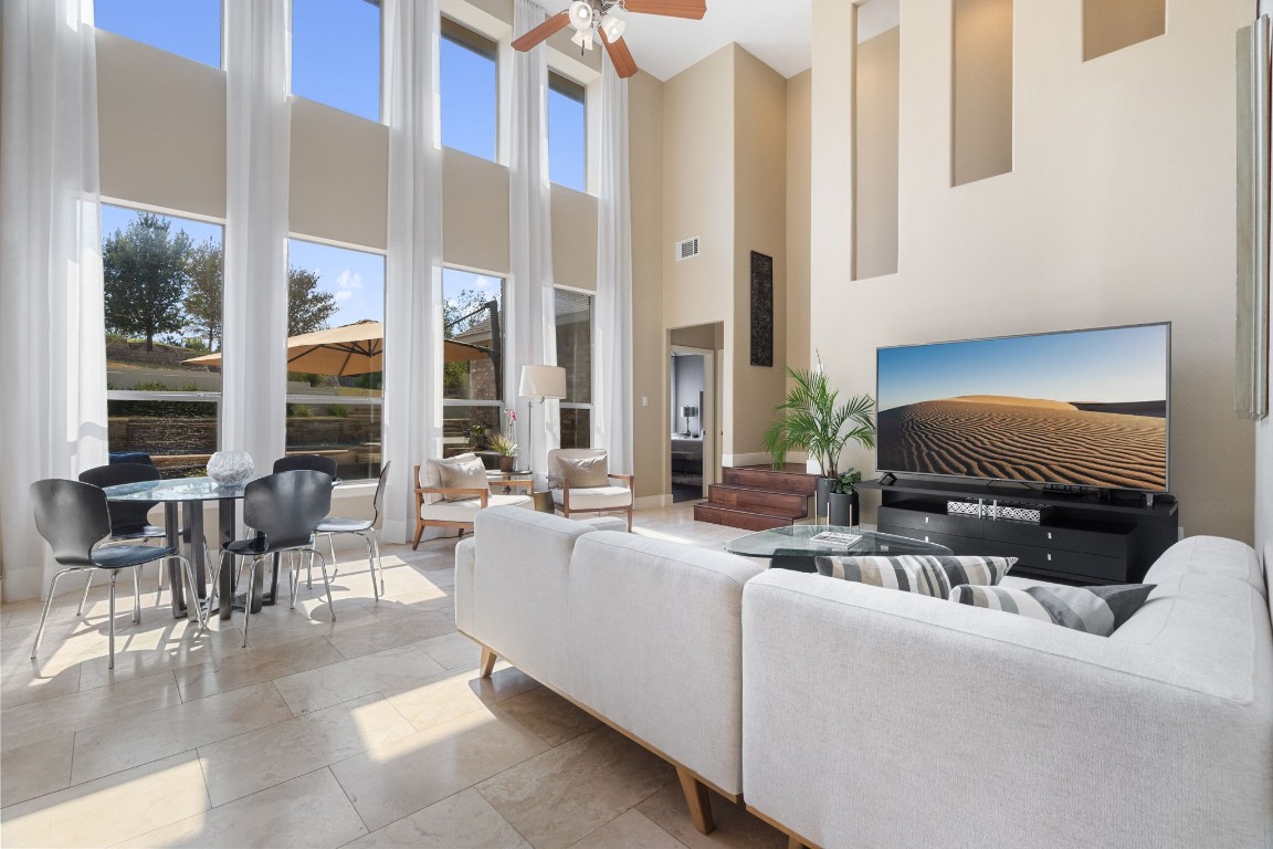 a living room with furniture and floor to ceiling windows