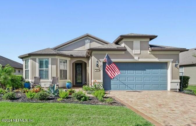 a front view of a house with a garden