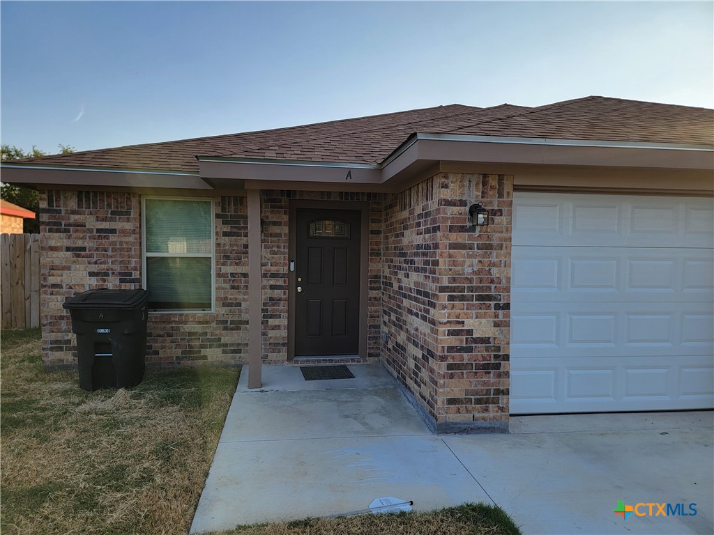 a front view of a house with a brick wall