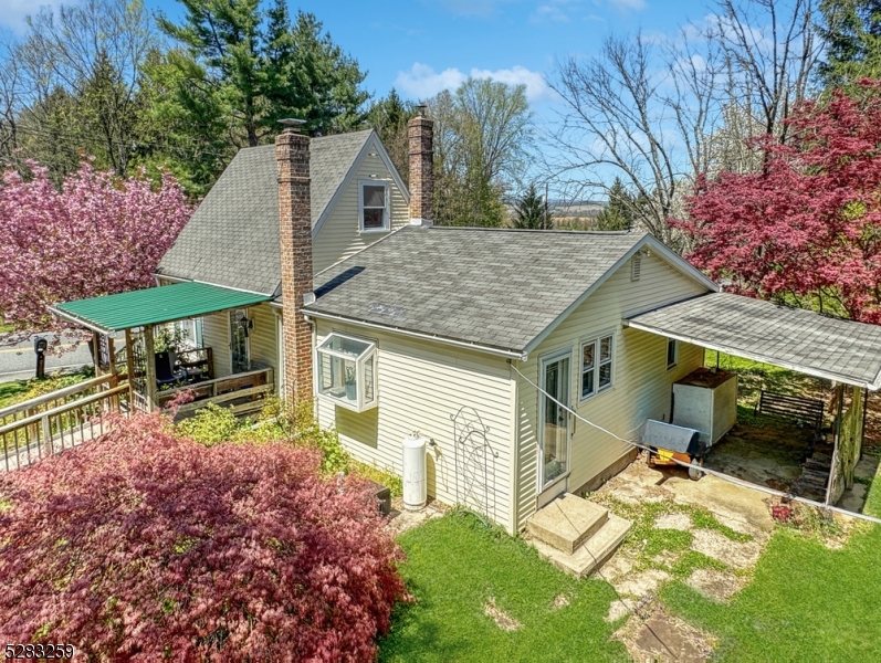 a view of house with backyard and furniture