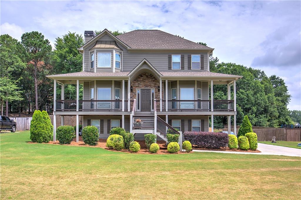 a front view of a house with a garden and porch