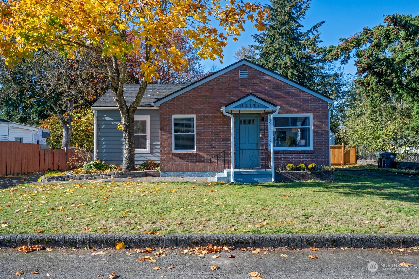 a house that has a tree in front of the house