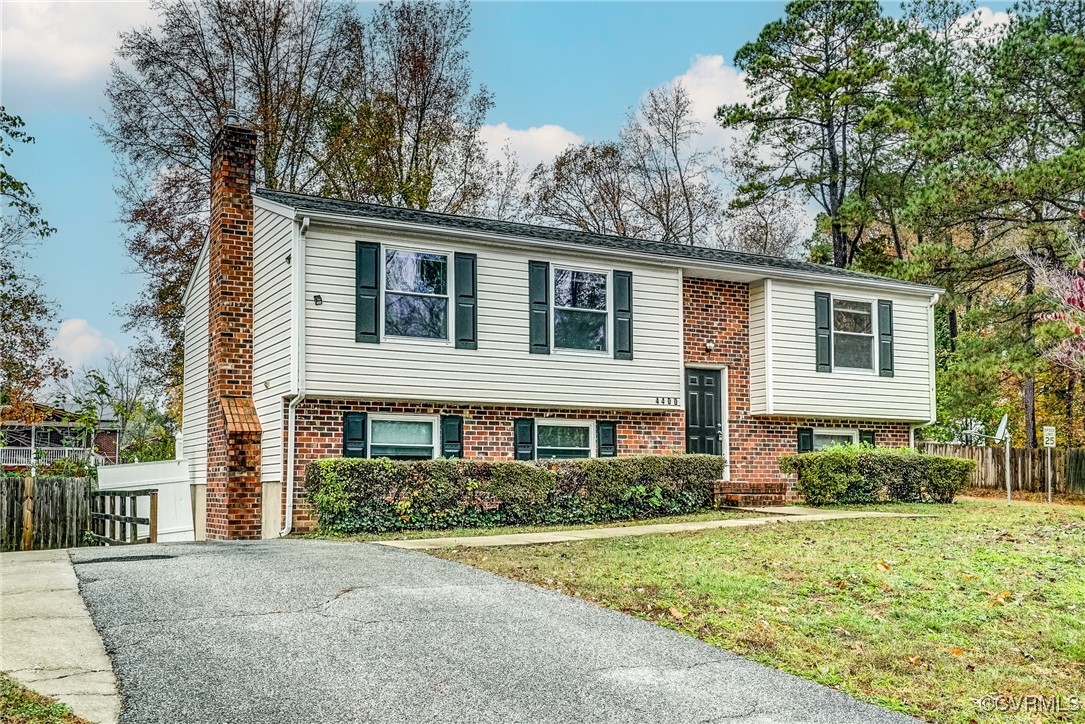 Split foyer home featuring a front lawn