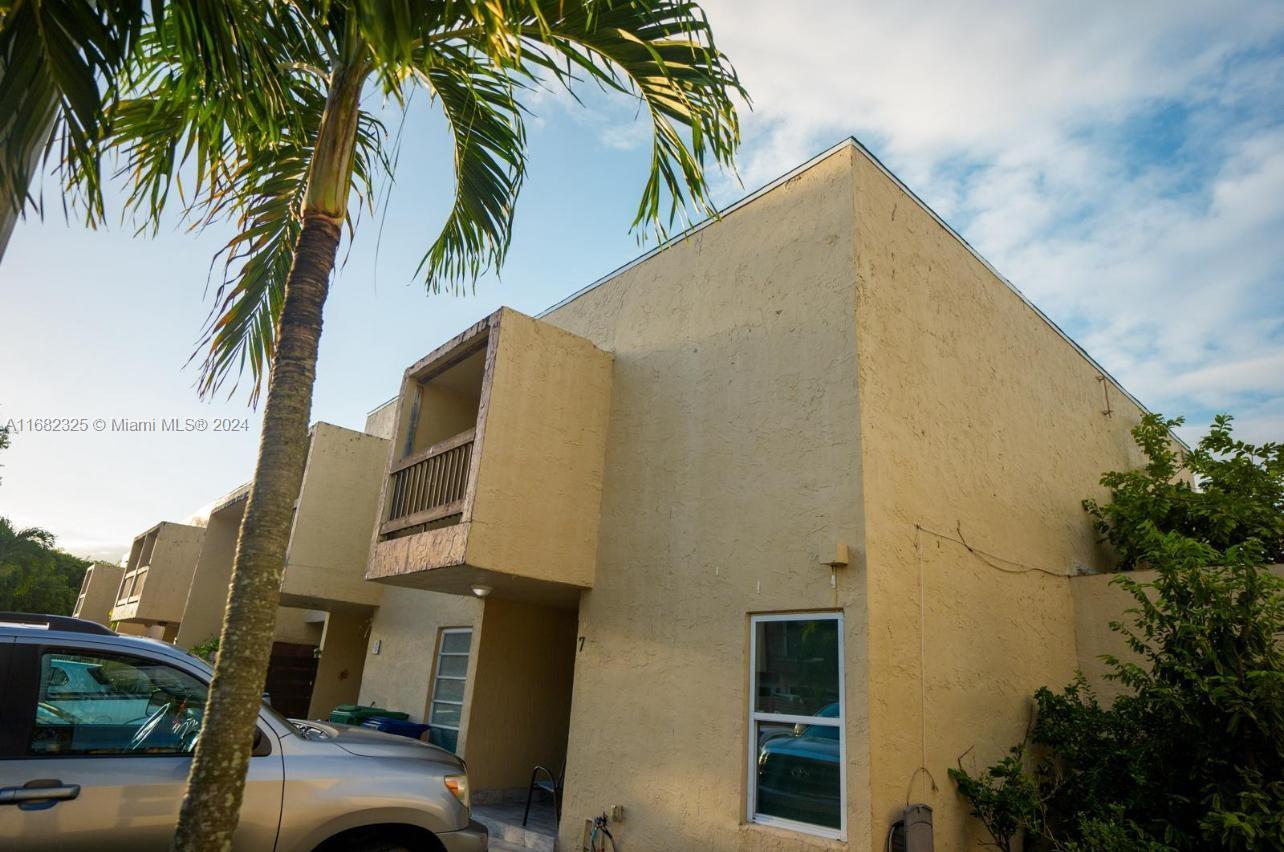 a view of a house with a palm tree