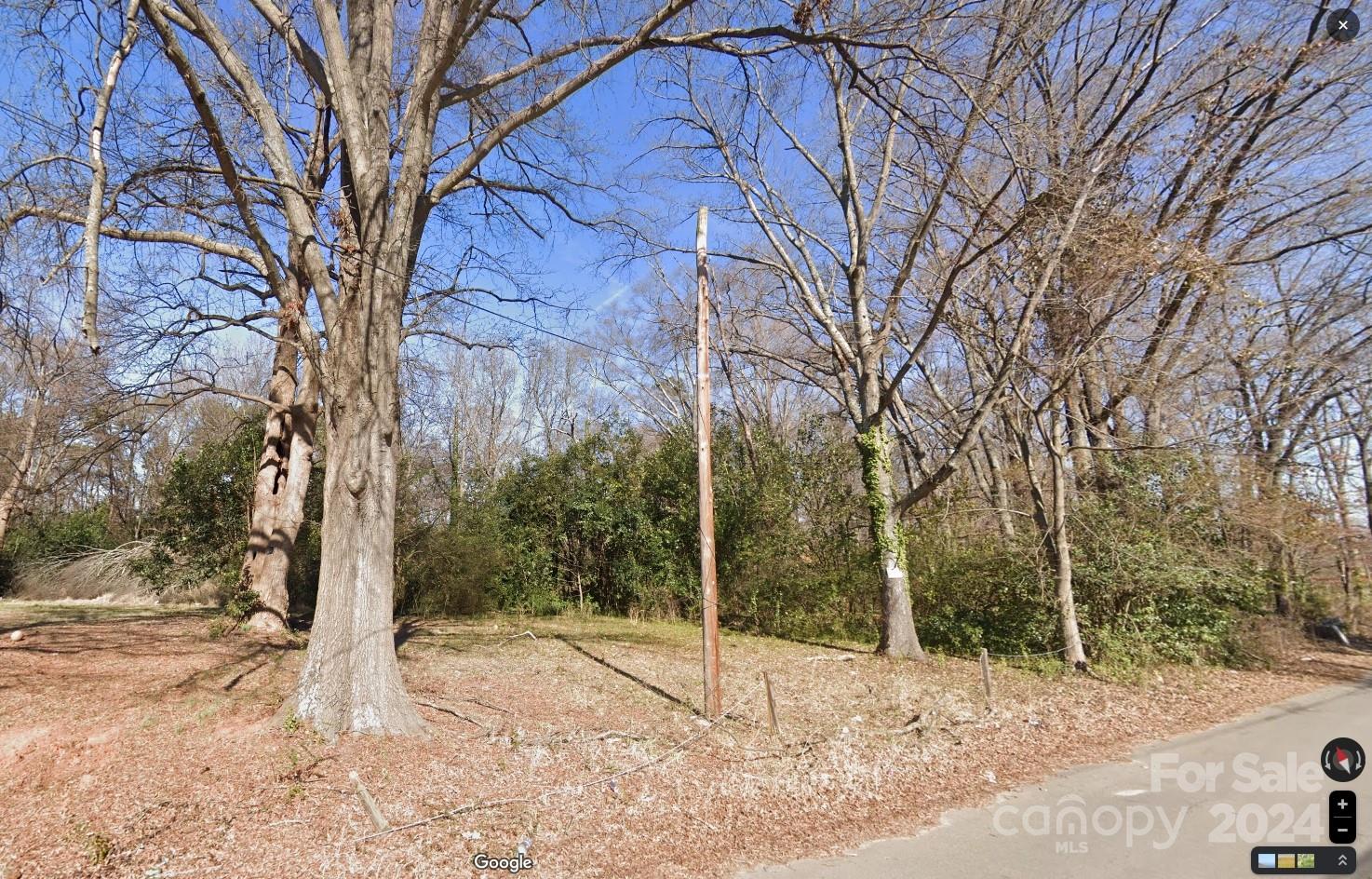 a backyard of a house with large trees