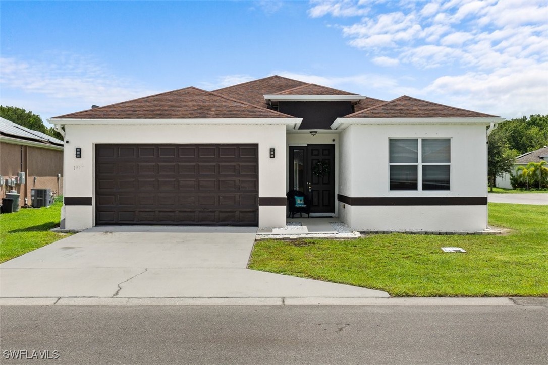 a front view of a house with a yard and garage