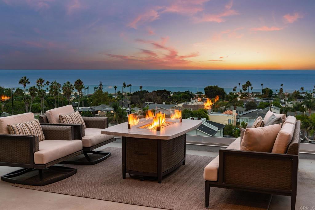 a view of a terrace with couches and sky view