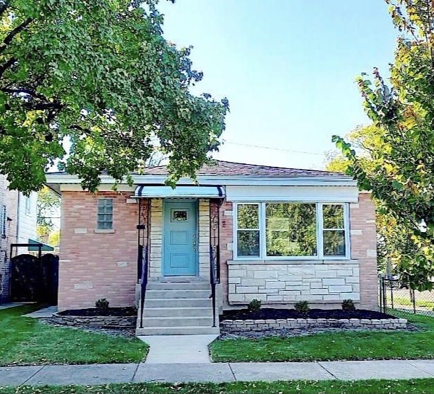 a front view of a house with a garden