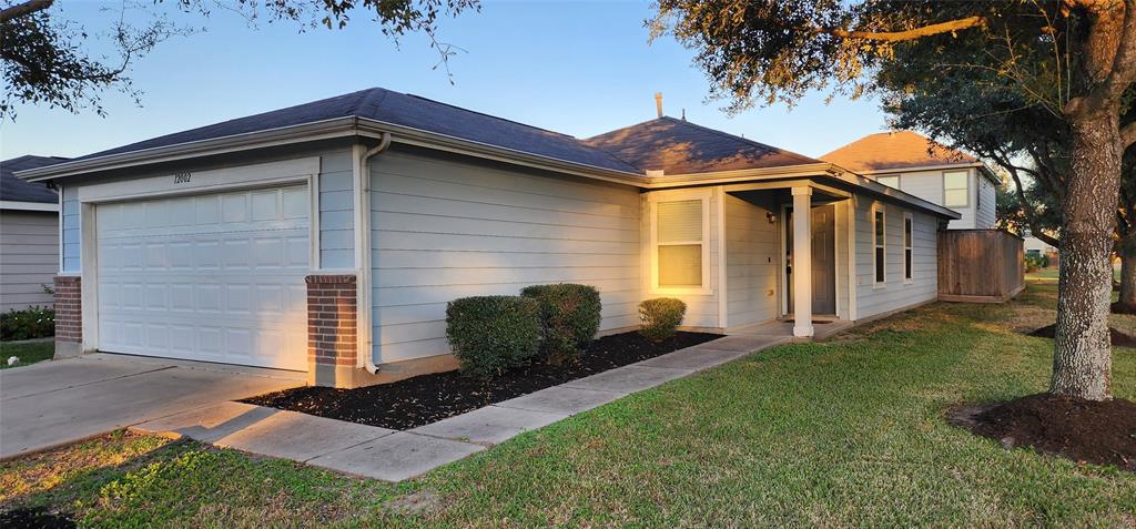 Charming corner-lot home with manicured landscaping and a welcoming front porch.