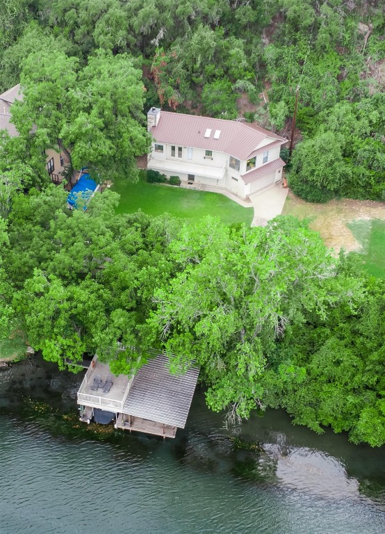 an aerial view of a house with yard and outdoor seating