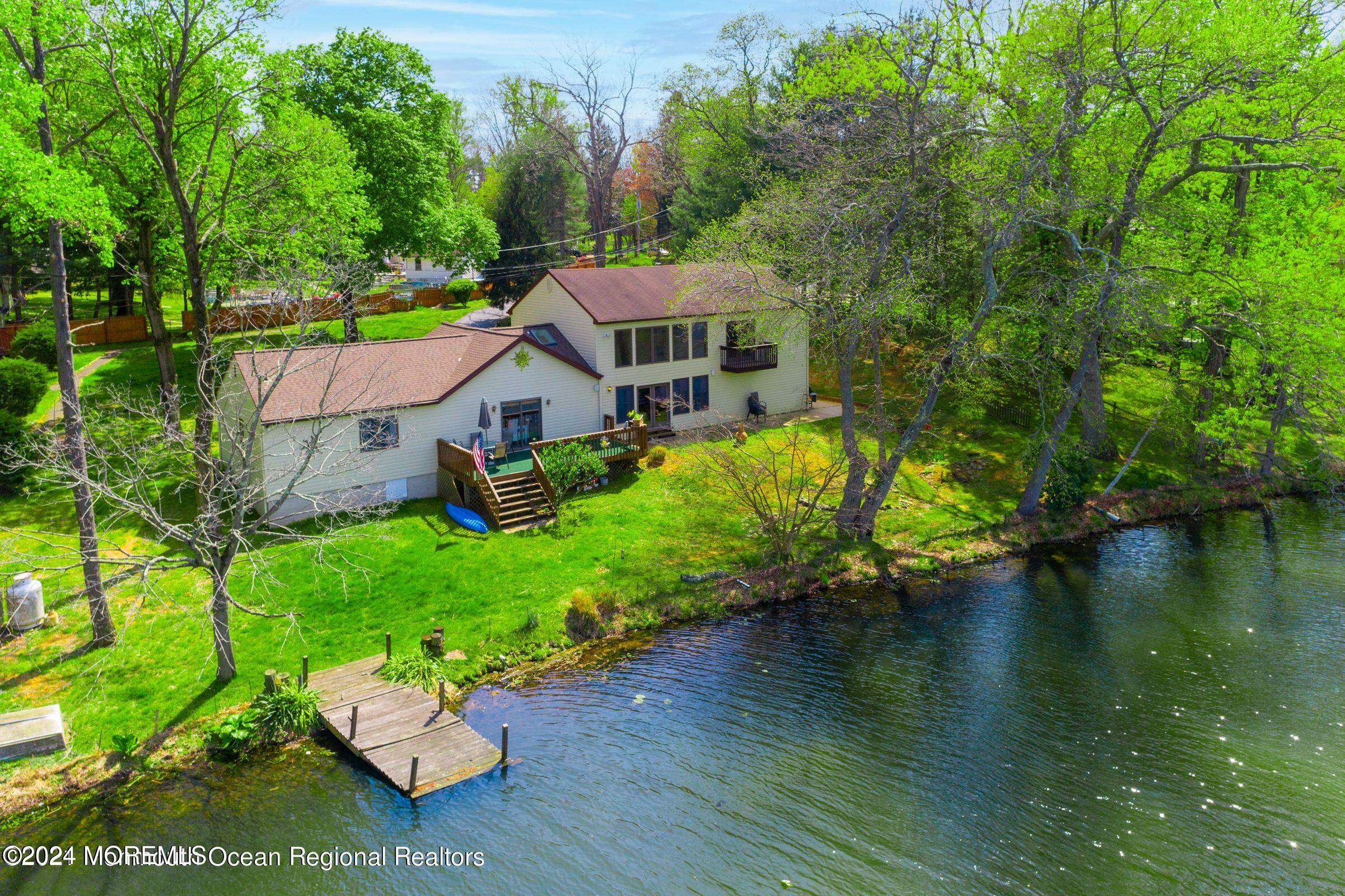 an aerial view of a house with a yard basket ball court and trampoline