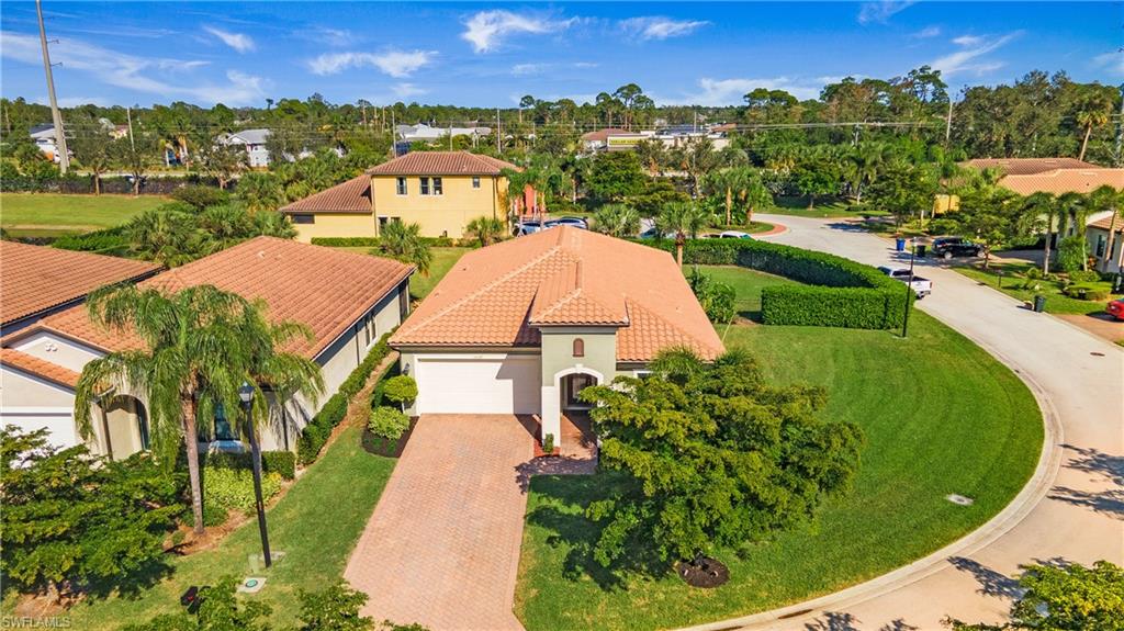 an aerial view of a house with a garden and lake view