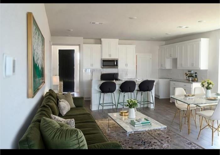 a living room with furniture a rug and a flat screen tv