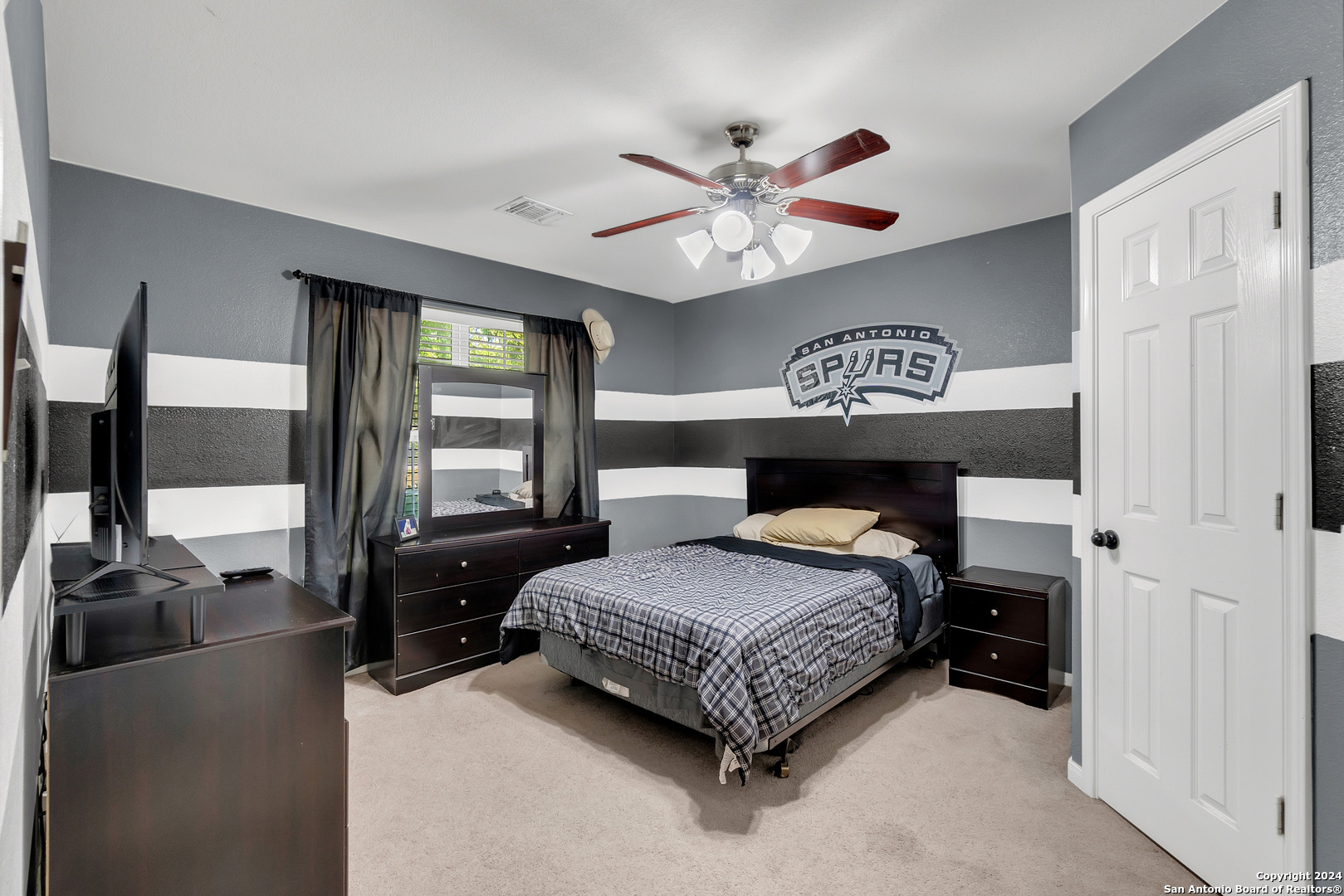 a bedroom with a bed and glass walk in closet